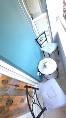 a room with a table and a chair and a table at Luminous Apartment in Mesochórion