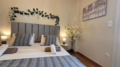 a bedroom with a large bed with two pillows at Luminous Apartment in Mesochórion