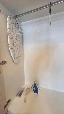 a bathroom with a window and a white wall at Luminous Apartment in Mesochórion