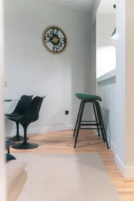 a room with a stool and a clock on the wall at Skyline Spa Athens 020 in Athens