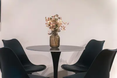 a table with a vase with flowers on it at Skyline Spa Athens 020 in Athens