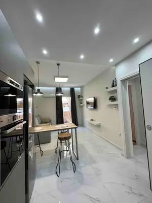 a kitchen with a table and chairs in a room at Downtown modern apartment in Athens