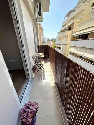a balcony of a building with flowers on it at Downtown modern apartment in Athens