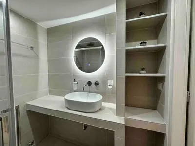 a bathroom with a white sink and a mirror at Downtown modern apartment in Athens