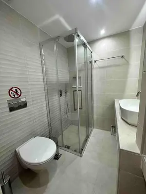 a bathroom with a shower and a toilet and a sink at Downtown modern apartment in Athens