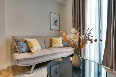a living room with a couch and a glass table at Skyline Spa Athens 310 in Athens