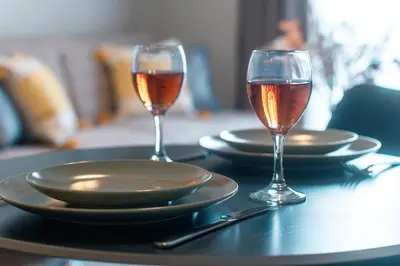 two glasses of wine are sitting on a table at Skyline Spa Athens 310 in Athens