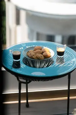 a blue table with a plate of cookies and two drinks at Skyline Spa Athens 310 in Athens
