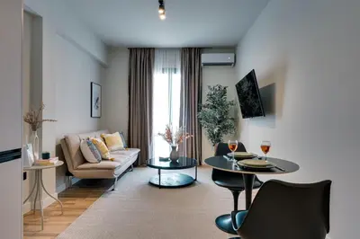 a living room with a couch and a table at Skyline Spa Athens 310 in Athens