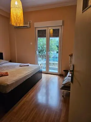 a bedroom with a bed and a view of a balcony at Apartment in Athens in Athens