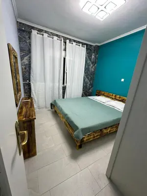 a bedroom with a bed and a blue wall at Lilia Apartments in Athens