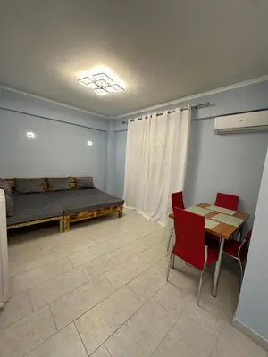 a room with a bed and a table and chairs at Lilia Apartments in Athens