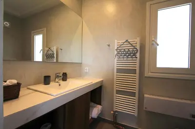 a bathroom with a sink and a mirror at Lida Garden Loft in Anavissos