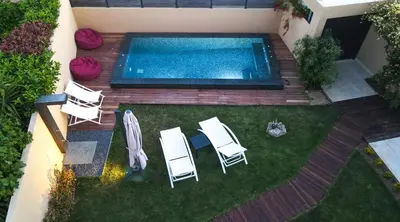 an overhead view of a backyard with a pool and chairs at Lida Garden Loft in Anavissos