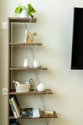 a book shelf with vases and baskets on it at Sunny and friendly apartment in Piraeus