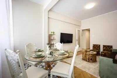 a dining room with a glass table and chairs at Sunny and friendly apartment in Piraeus