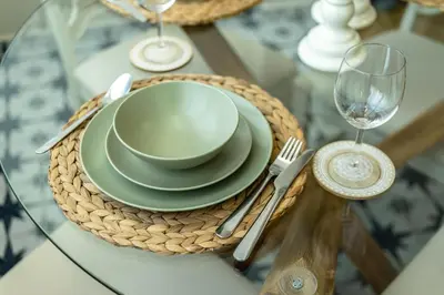 a table with a bowl and a plate on a glass table at Sunny and friendly apartment in Piraeus