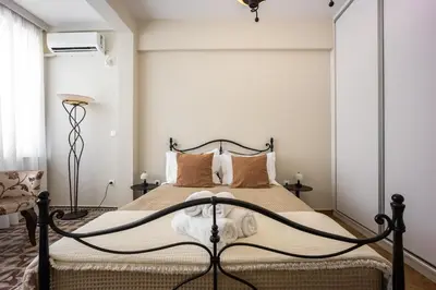 a bedroom with a bed with a black frame at Sunny and friendly apartment in Piraeus