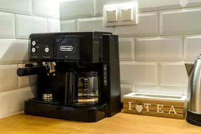 a black coffee maker sitting on top of a counter at Sunny and friendly apartment in Piraeus