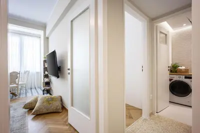 a hallway with a door leading to a laundry room at Sunny and friendly apartment in Piraeus