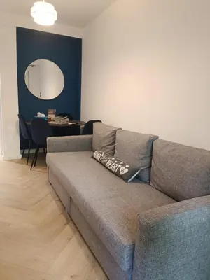 a living room with a couch and a table at Blue Beach Apartment in Athens Alimos Kalamaki in Athens
