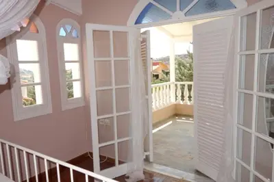 a room with an open door to a balcony at Villa Dendron in Aghia Marina