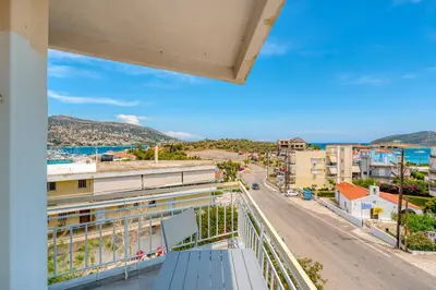 a balcony with a view of a street at Royal Fig Apartment Porto Rafti in Porto Rafti