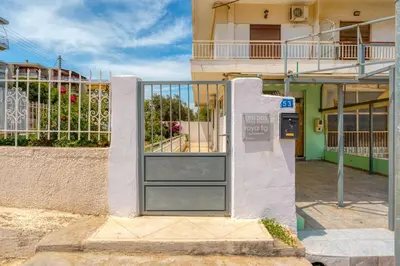 a door in the side of a building at Royal Fig Apartment Porto Rafti in Porto Rafti