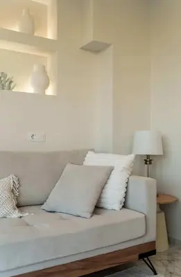 a living room with a couch with pillows on it at Luxury Modern Apartment with Stunning Glyfada View in Athens