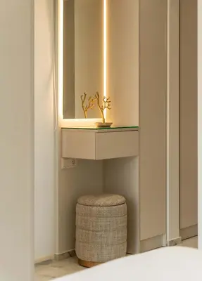 a bathroom with a sink and a stool under a mirror at Luxury Modern Apartment with Stunning Glyfada View in Athens