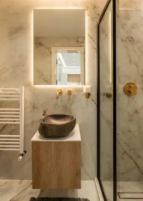 a bathroom with a sink and a mirror at Luxury Modern Apartment with Stunning Glyfada View in Athens
