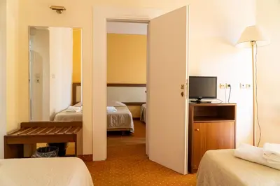 a hotel room with two beds and a television at Four Seasons Hotel in Athens