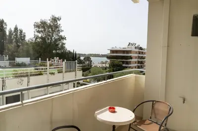 a balcony with a table and chairs and a view at Four Seasons Hotel in Athens