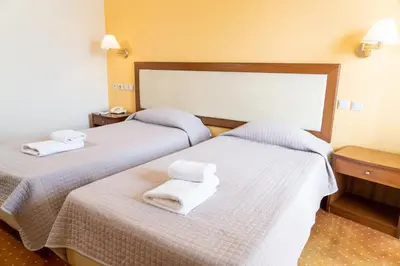 two beds in a hotel room with towels on them at Four Seasons Hotel in Athens