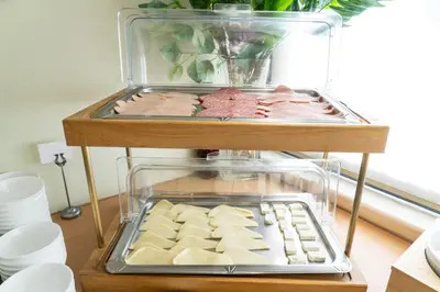 a display case with cheese and other pastries on a table at Four Seasons Hotel in Athens
