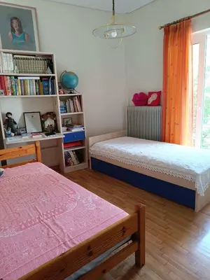 a bedroom with two beds and a book shelf at Chalandri Bloom Residence 2BR Sleeps 6 in Athens