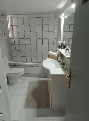 a white bathroom with a toilet and a sink at Chalandri Bloom Residence 2BR Sleeps 6 in Athens
