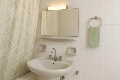 a bathroom with a sink and a mirror at Central, Quiet & Comfortable Apartment in Athens