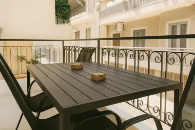 a wooden table with two boxes on a balcony at Central, Quiet & Comfortable Apartment in Athens