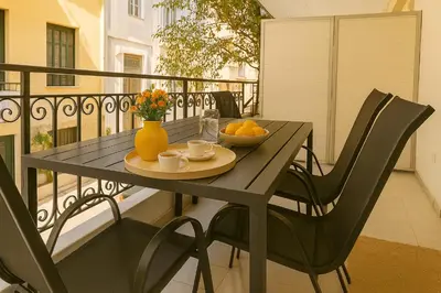 a table with a bowl of fruit on a balcony at Central, Quiet & Comfortable Apartment in Athens