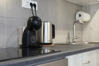 a kitchen counter with a coffee maker and a sink at Serene & Stylish apt by GHH in Athens