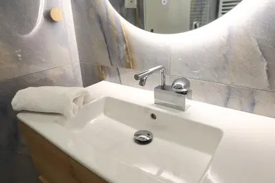 a white sink in a bathroom with a mirror at Serene & Stylish apt by GHH in Athens