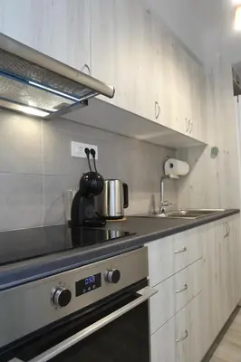 a kitchen with a stove with a pot on it at Serene & Stylish apt by GHH in Athens