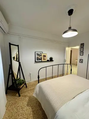a bedroom with a bed and a mirror in it at Mosaic Apartment in Athens