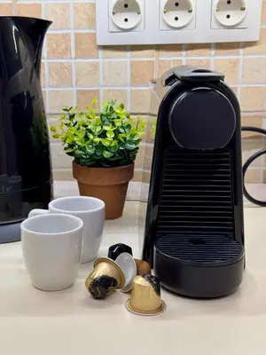 a black toaster sitting on a kitchen counter next to cups at Mosaic Apartment in Athens
