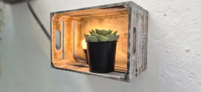a black vase with a plant on a wall at Mosaic Apartment in Athens