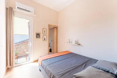 a bedroom with a bed and a large window at B2 Porto Living in Piraeus