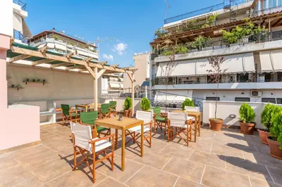 a patio with tables and chairs on top of a building at B2 Porto Living in Piraeus
