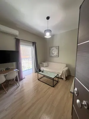 a room with a bed and a table and a window at Μοντέρνο διαμέρισμα στη Δάφνη in Athens