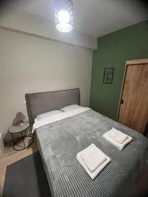 a bedroom with a bed with two towels on it at Μοντέρνο διαμέρισμα στη Δάφνη in Athens